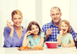 © Syda Productions - happy family with two kids eating at home