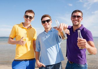 Poster - happy friends with beer bottles on beach