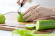 close up of woman hands chopping green vegetables