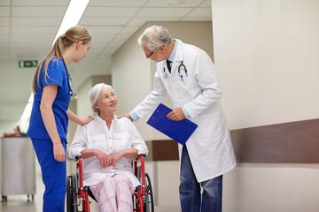 Canvas Print - medics and senior woman in wheelchair at hospital