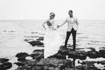 beautiful  gorgeous blonde bride  and stylish groom, on the background of a sea, wedding ceremony  on cyprus.