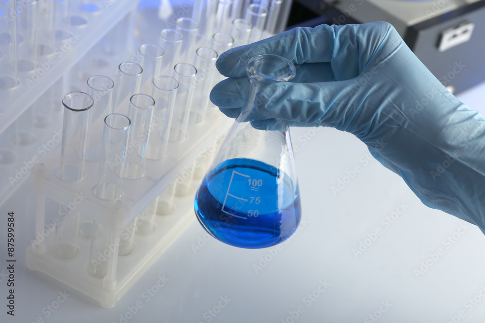 Test tube in scientist hand in laboratory