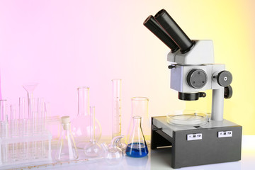 Wall Mural - test tubes and microscope on bright background