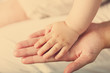 © Africa Studio - Adult and baby hands, closeup
