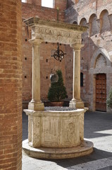 Wall Mural - Old stone water well in Tuscany, Italy