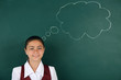 © Africa Studio - Beautiful little girl standing near blackboard
