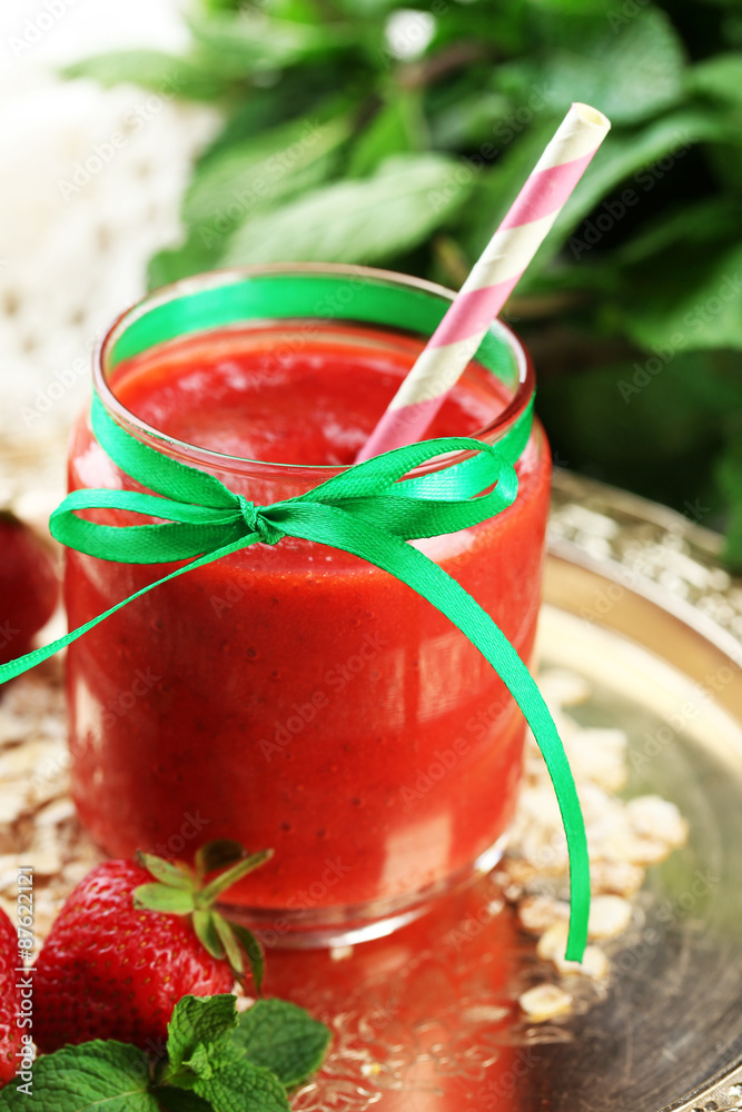 Strawberry smoothie on wooden table background