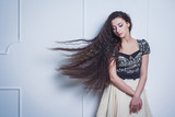 Fototapeta  - Pretty young woman with closed eyes and long hair