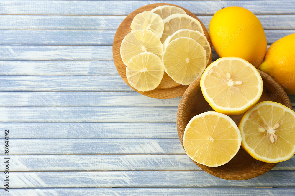 Ripe lemons on wooden table close up
