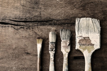 Grunge Paintbrush On Old Wood Background With Copy Space