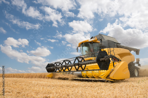Fotografie, Obraz close view of modern combine harvester in action.