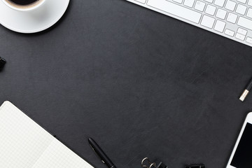 Office desk table with computer, supplies and coffee cup