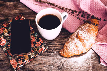 Fresh croissant with cup of hot coffee