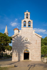 Wall Mural - Old church with high bell tower in Budva