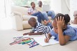 © WavebreakmediaMicro - Happy siblings on the floor drawing
