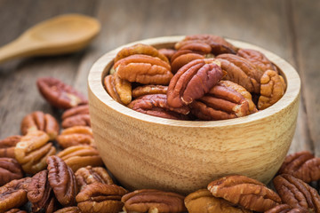 Wall Mural - Pecan nuts in wooden bowl
