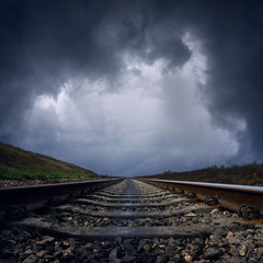 Wall Mural - dramatic clouds over railroad to horizon