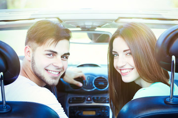 Beautiful couple in cabriolet, outdoors