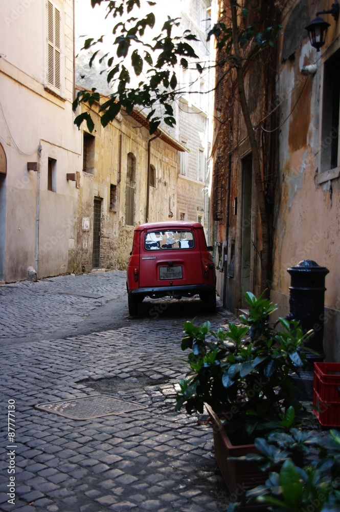Obraz na płótnie The narrow romantic Roman street and the old red car w salonie