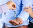 © Africa Studio - Real estate agent giving keys to young couple, closeup