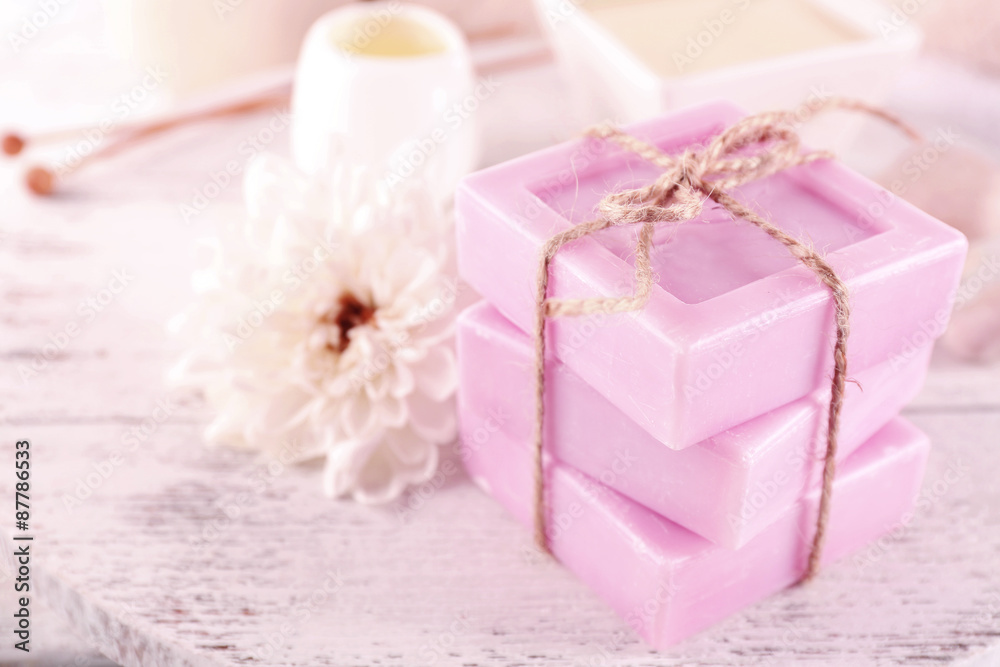 Stack of tied spa soap on wooden table, closeup