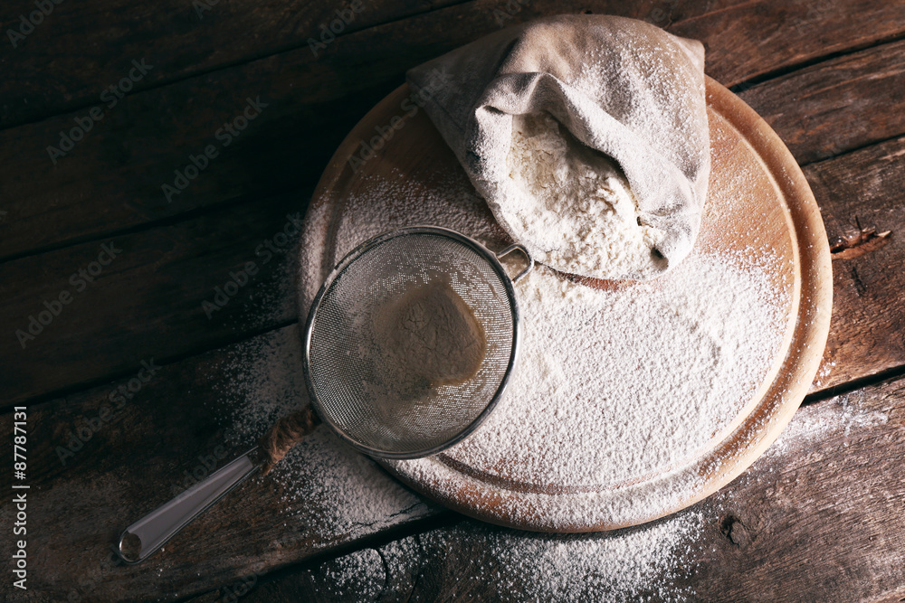 White flour on cutting board on wooden table background