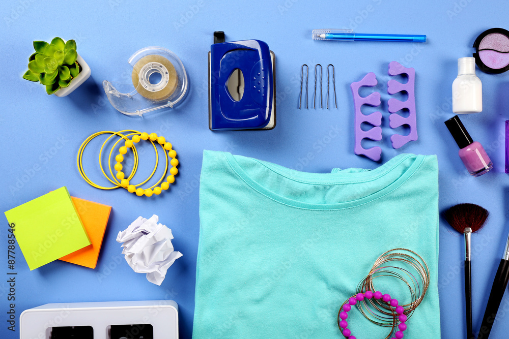 Modern female clothing and accessories on color background