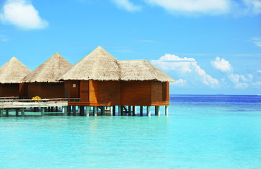 Canvas Print - View of beautiful blue ocean water and bungalows in Baros Maldives