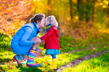 Mother and child playing in an autumn park