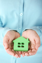 Wall Mural - Female hands holding house, closeup