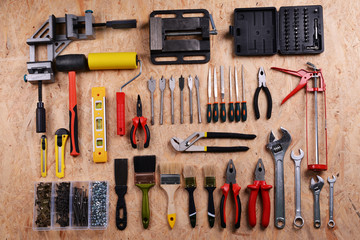 Set of tools on plywood, top view