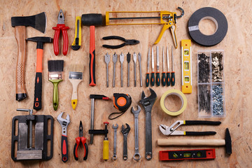 Set of tools on plywood, top view