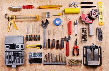 Set of tools on plywood, top view