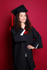 Poster - Studio portrait picture from a young graduation woman on red background