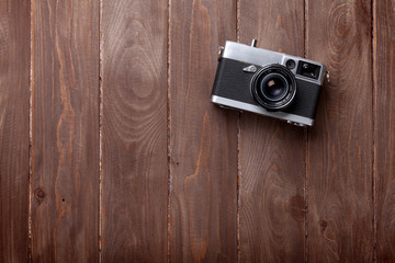 Poster - Vintage film camera on wooden table