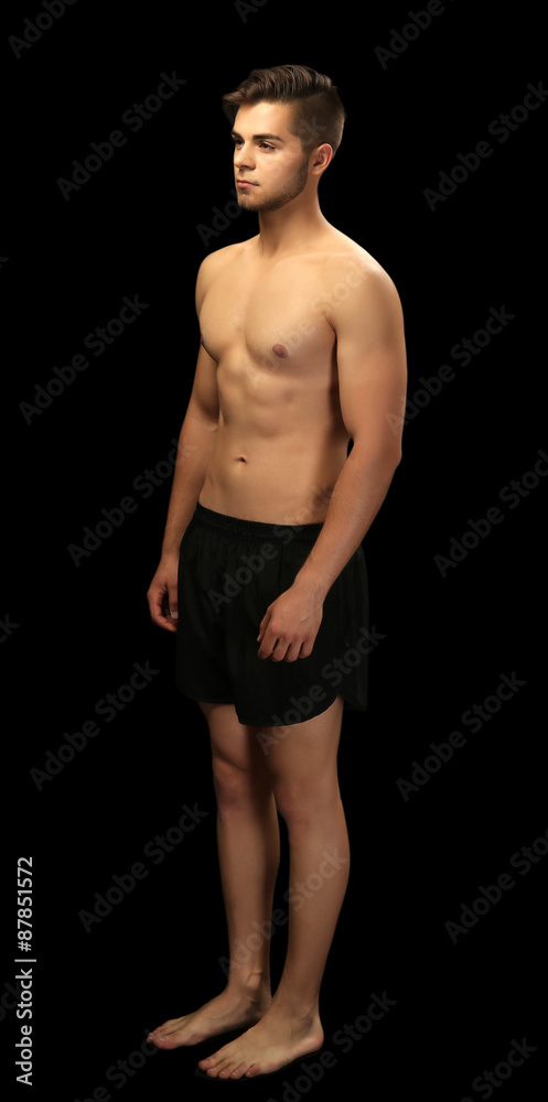 Muscle young man on dark background