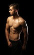 © Africa Studio - Muscle young man on dark background