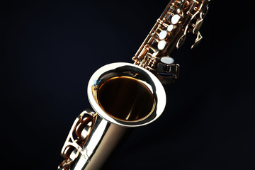 Golden saxophone on dark background