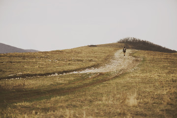 Canvas Print - Hiker woman go up on hill