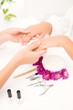 © WavebreakMediaMicro - Beautician filing female clients nails at spa beauty salon