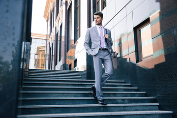 Sticker - Businessman walking on stairs outdoors