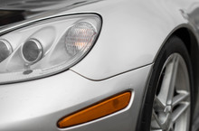Close-up View Of Silver Sports Car Headlight.
