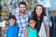 © WavebreakmediaMicro - Portrait of a happy family having fun in the mall