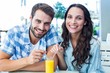 © WavebreakmediaMicro - Cute couple sitting in cafe