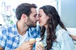 © WavebreakmediaMicro - Couple kissing while holding cupcakes