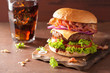 bacon cheese burger with beef patty tomato onion cola