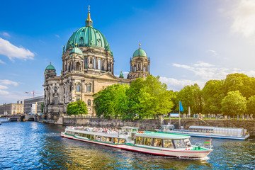 Wall Mural - Famous Berlin Cathedral at Museumsinsel with excursion boat on Spree river at sunset, Berlin, Germany