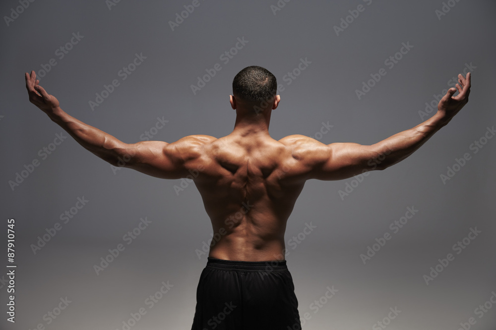 Male bodybuilder raising his arms, back view Stock Photo | Adobe Stock