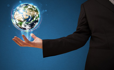 Wall Mural - Businessman holding a glowing earth globe