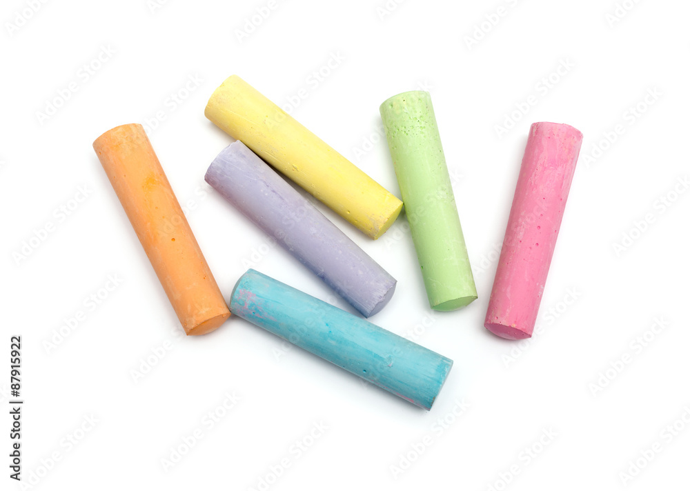 chalks in a variety of colors arranged on a white background - obrazy, fototapety, plakaty 
